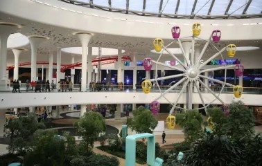 Indoor Ferris wheel inside the Respublika Park shopping center among green areas