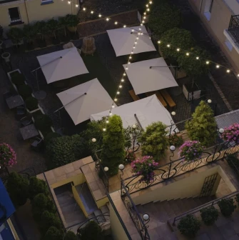 Vozdvyzhenskyi in Kyiv - overhead view of courtyard with white umbrellas and lights