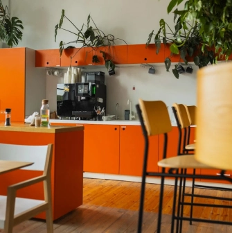 Kooperativ - minimalist communal kitchen area with stainless steel appliances