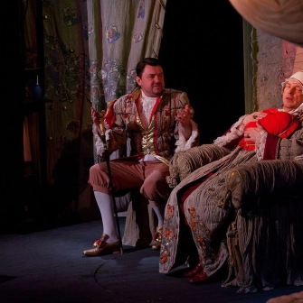 Teatr Koleso in Kyiv - theatrical scene with actors in vintage costumes performing on stage