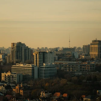 Motherland - panoramic view of the Kyiv city skyline featuring modern high-rise buildings during golden hour
