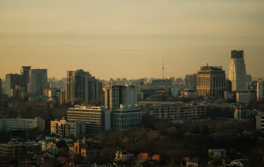 Motherland - panoramic view of the Kyiv city skyline featuring modern high-rise buildings during golden hour