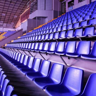 Palats Sportu in Kyiv - empty rows of blue seats rising steeply towards the ceiling structure of the arena