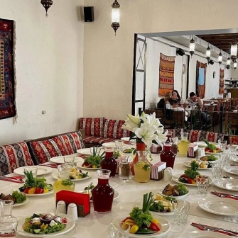 Banquet table with traditional dishes at Musafir restaurant in Kyiv