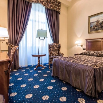 Room with a double bed at the Premier Palace Hotel in Kyiv, decorated in a classic style