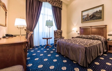 Room with a double bed at the Premier Palace Hotel in Kyiv, decorated in a classic style