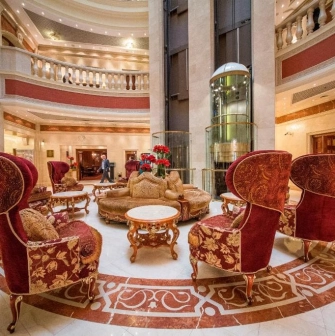Premier Palace Hotel lobby in Kyiv with red armchairs and elevator