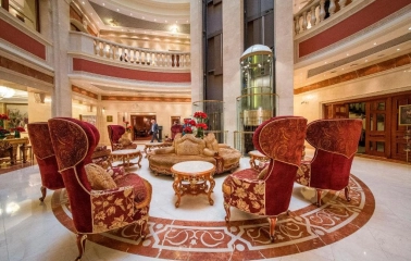 Premier Palace Hotel lobby in Kyiv with red armchairs and elevator