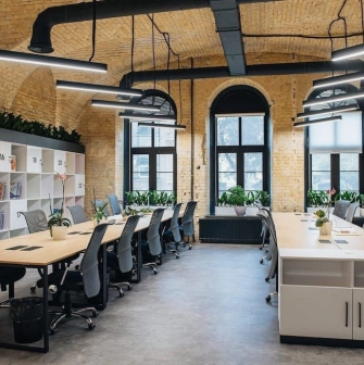 Coworking space with wooden tables and office chairs at Generator in Kyiv