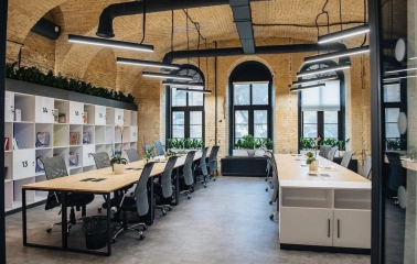 Coworking space with wooden tables and office chairs at Generator in Kyiv