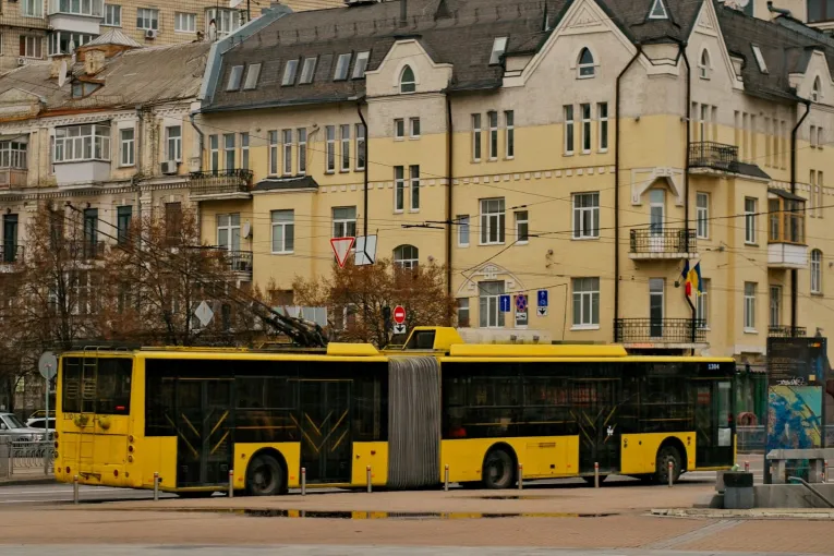 Yellow trolleybus driving in Kyiv city center