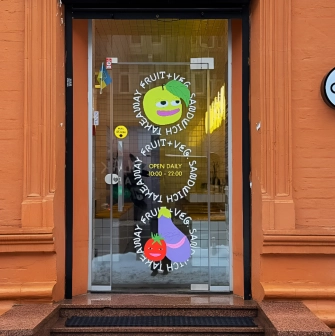 Fruit & Veg - light green painted cafe facade with large windows and simple sign