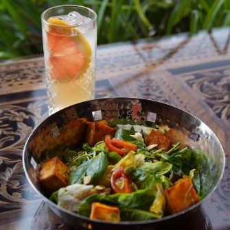 Salad with greens and a citrus drink at restaurant Himalaya