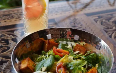 Salad with greens and a citrus drink at restaurant Himalaya
