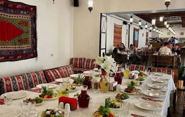 Banquet table with traditional dishes at Musafir restaurant in Kyiv
