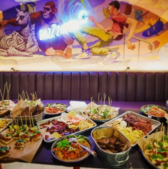 Punkraft - overhead view of a hearty appetizer plate and a food menu