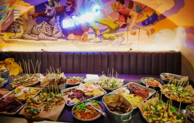 Punkraft - overhead view of a hearty appetizer plate and a food menu