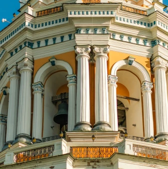 Kyiv Pechersk Lavra - the Great Lavra Bell Tower with white columns and a visible bell inside