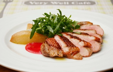 Restaurant Very Well Cafe - close-up view of a steak dish with potato wedges and fresh herbs