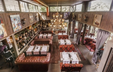 Restaurant Kanapa - overhead view of a multi-level dining room with leather and patterned seating
