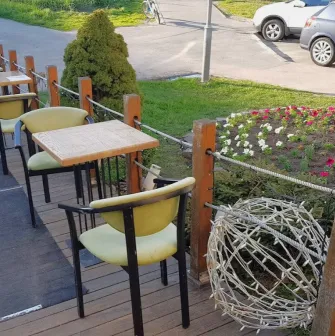 Restaurant Kukhnya Polli - outdoor terrace dining area with simple tables and chairs