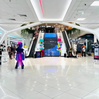 Gorodok Gallery in Kyiv - interior atrium view with escalators, bright lighting, and ice cream cone decorations