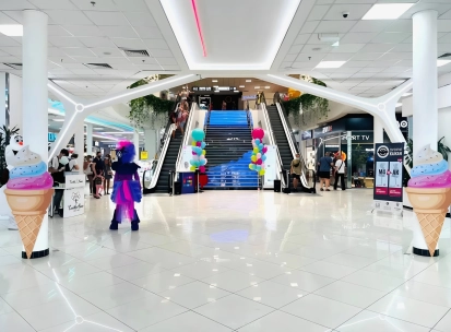 Gorodok Gallery in Kyiv - interior atrium view with escalators, bright lighting, and ice cream cone decorations