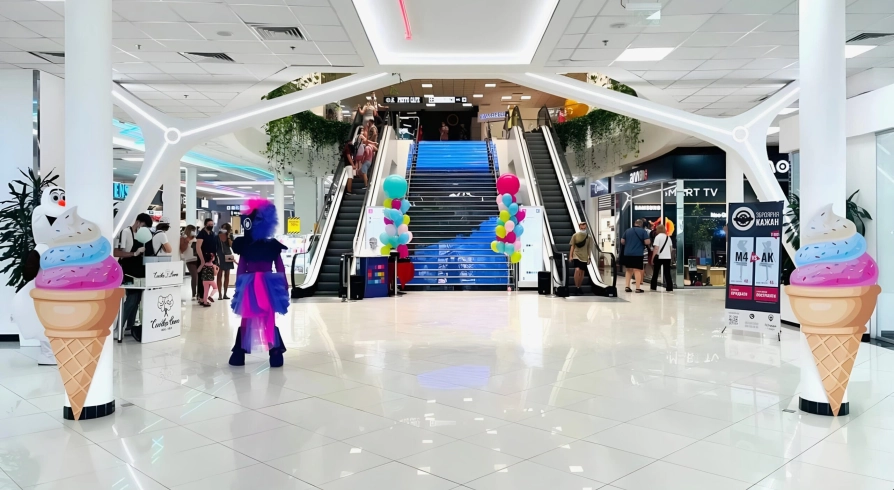 Gorodok Gallery in Kyiv - interior atrium view with escalators, bright lighting, and ice cream cone decorations