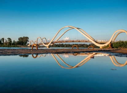 Azov Wave Bridge in Kyiv - white wave-shaped bridge reflecting in the water surface