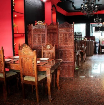 Restaurant interior with carved wooden chairs and dividers