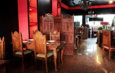 Restaurant interior with carved wooden chairs and dividers