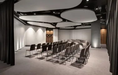 IQ Business Center in Kyiv - empty conference room with curved rows of chairs and screen