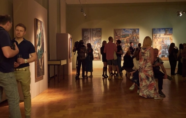 Natsionalnyi Khudozhnii Muzei Ukrainy in Kyiv - elegant exhibition room with burgundy walls covered in framed classic paintings and antique