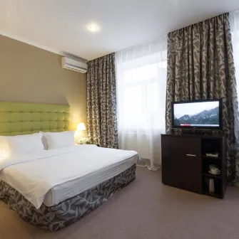 Standard room with a green bed headboard at Bontiak Hotel