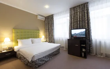 Standard room with a green bed headboard at Bontiak Hotel