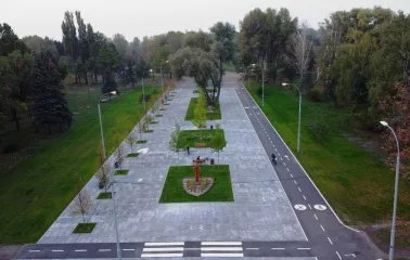 Muromets park - aerial view of the renovated main alley featuring a paved pedestrian promenade, benches, and a marked bicycle lane