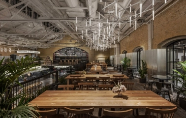 Kyiv Food Market interior with wooden tables, food courts around the perimeter and high ceiling