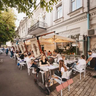 Chornomorka - street terrace with tables and umbrellas