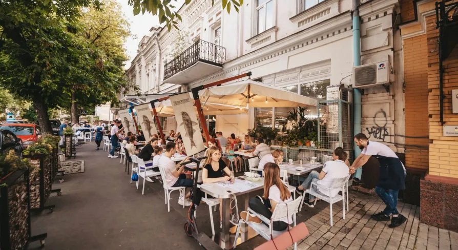Chornomorka - street terrace with tables and umbrellas