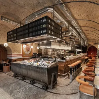 Fish Fetish – industrial-style seafood bar with arched brick ceiling and fresh fish display