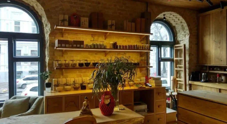 Interior of Chaism tea house in Kyiv with wooden furniture and arched windows