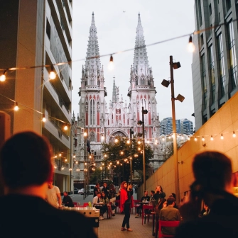 One Love Coffee in Kyiv - outdoor terrace with string lights and cathedral view
