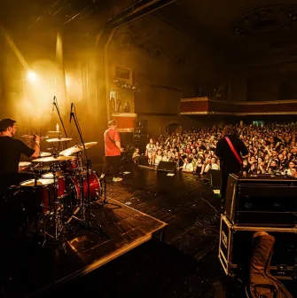 Mala Opera in Kyiv - live music performance in the vintage hall with a drummer on stage overlooking a dense crowd of excited fans