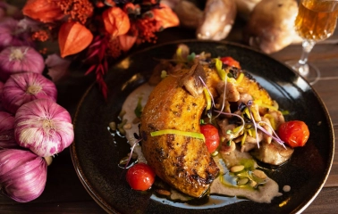 Khutorets na Dnipri – baked pumpkin with mushrooms, cherry tomatoes and creamy sauce, styled with autumn decor