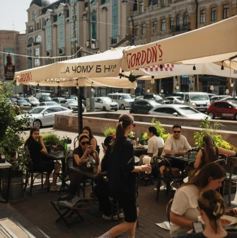 Mimosa Brooklyn Pizza - outdoor terrace with guests dining under umbrellas