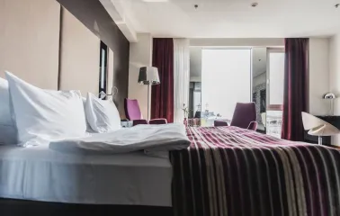 Spacious room at 11 Mirrors Design Hotel in Kyiv with a panoramic window, modern interior and city views