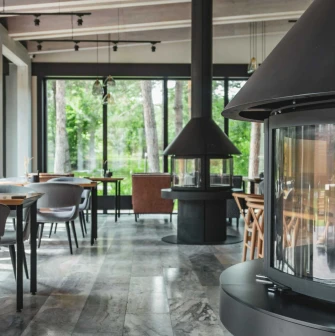 Interior of the Sobi Club restaurant with large windows and a fireplace