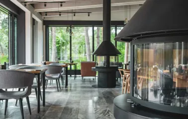 Interior of the Sobi Club restaurant with large windows and a fireplace