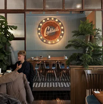 Milk Bar - vibrant interior featuring a neon sign and modern, stylish furniture