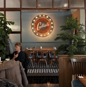 Milk Bar - vibrant interior featuring a neon sign and modern, stylish furniture